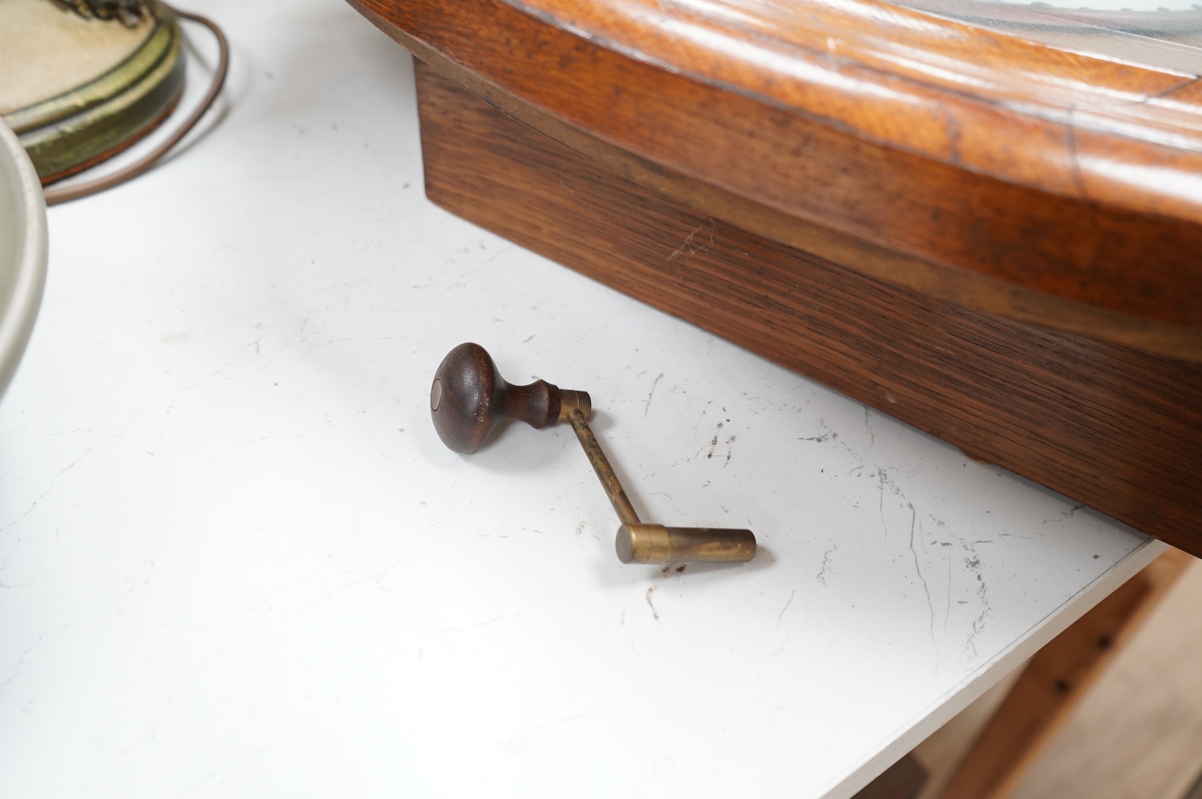 A French oak oval wall clock, the dial inscribed Any. Bailly A Lyon, with pendulum and key, 68cm high